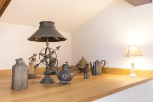 a table with a lamp and various items on it at Residence SanMarco in Venice