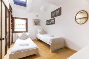 a bedroom with two beds and a mirror at Residence SanMarco in Venice