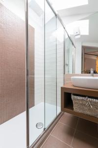 a bathroom with a glass shower and a sink at Residence SanMarco in Venice +30 photos