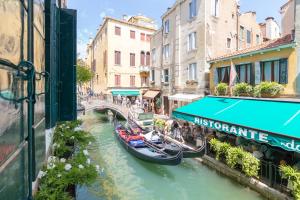 a group of gondolas on a canal in a city at Residence SanMarco in Venice