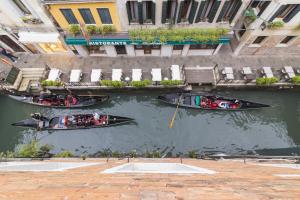 a group of people in boats in the water at Residence SanMarco in Venice