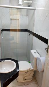 a bathroom with a toilet and a sink at Hotel Piramide St. Antonio de Jesus in Santo Antônio de Jesus