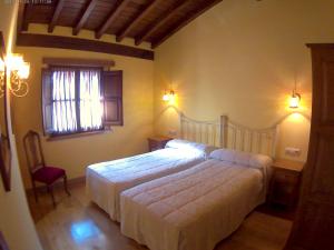 Ein Bett oder Betten in einem Zimmer der Unterkunft Apartamentos Casa Celia