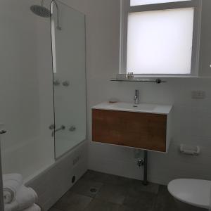 a bathroom with a sink and a shower with a window at Northern Star Hotel in Hamilton