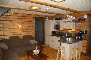 a living room with a couch and a kitchen at Madsa Recreational Center in Otepää