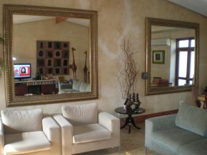 a living room with a couch and a mirror at Gordons Guesthouse in Cape Town