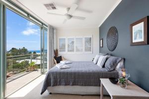 a woman laying on a bed in a bedroom at Avoca Palms Resort in Avoca Beach