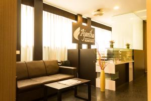 a waiting room with a couch and a table at Ajantha Komforts, Bengaluru in Bangalore