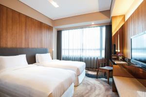 Katil atau katil-katil dalam bilik di Home Hotel