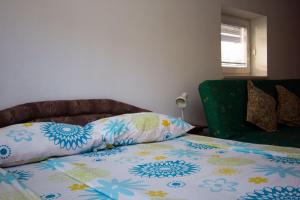 a bed with a pillow on top of it at Apartment Mavrica in Bovec