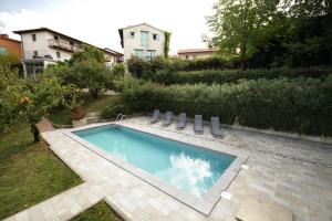 a swimming pool in the backyard of a house at Dvor Hotel in Dobrovo