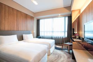 Katil atau katil-katil dalam bilik di Home Hotel