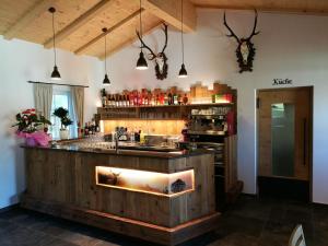 a kitchen with a bar with a fireplace at Dillerhof in Laion