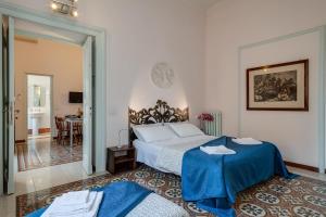 a bedroom with a bed with a blue blanket at Otium Maecenatis Apartments in Rome