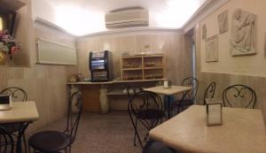 a room with tables and chairs in a restaurant at Hotel Prati in Rome