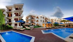 a hotel with a swimming pool in front of a building at Hotel Korali in Troulos