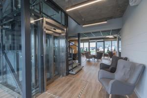 an office with chairs and tables and glass walls at Air Hotel in Karmėlava