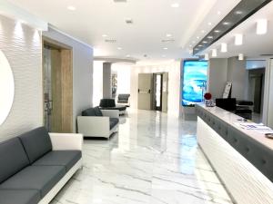 a lobby with couches and a television in a building at Hotel Blu in Porto Cesareo