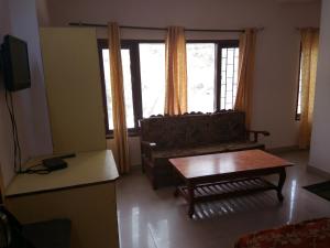 a living room with a couch and a coffee table at Celebrations Homestay in Shimla