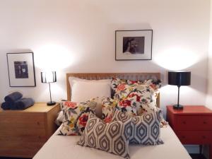 a bedroom with a bed with pillows and two lamps at Lonja Valencia Flats in Valencia