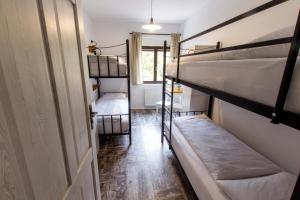 a room with two bunk beds and a door at Hostel Hildegarden in Tolmin