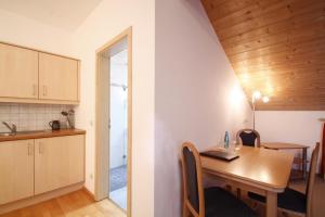 a kitchen and dining room with a table and chairs at Hotel-Cafe Hanfstingl in Egling