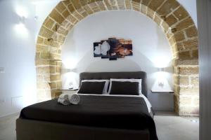 En eller flere senge i et værelse på Appartamenti Maniace