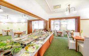 a dining room with a long table with food at Hotel Hetman in Warsaw