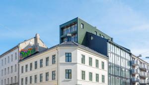 a building with a tall building on top of it at Frogner House - Grünerløkka in Oslo