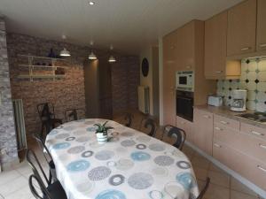 a kitchen with a table and chairs in a room at Family home with pond and terrace in Le Bizet