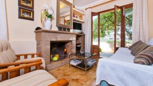 a living room with a fireplace and a couch at Casa CORA Alcudia in Port d'Alcudia