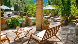 a patio with two chairs and a table at Finca GARROVERA Pollensa in Pollença