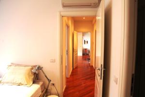 a hallway leading to a room with a bed and a hallway at The Jasmine Terrace Retreat in Bologna