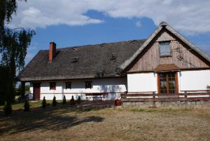 a large white house with a gambrel roof at GAMP Paweł Sawicki in Kleszczele