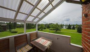 a screened in porch with a table and chairs at Hulda`s Apartment by the river in Heinola
