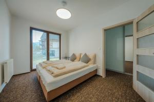 Postel nebo postele na pokoji v ubytování Village Resort Hanuliak Apartmany