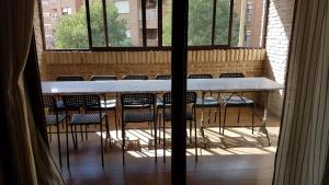 a view of a table and chairs from a window at Apartamento de Lujo Av. Barber in Toledo