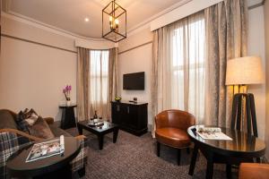 a living room with a couch and a table at Macdonald Burlington Hotel in Birmingham