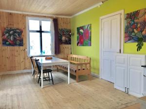 a dining room with a table and chairs and a window at Parkgatan villa in Krylbo