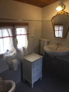 a bathroom with a sink and a toilet and a mirror at La Casa di Luigi in Montevarchi