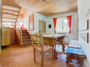 a room with a table and chairs and a staircase at Chata Špindlerův Mlýn 255 in Špindlerův Mlýn