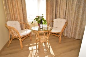 una mesa con dos sillas y una mesa con una planta. en Luxury Apartments, en Burgas