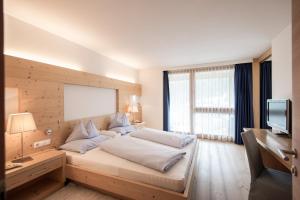 Voodi või voodid majutusasutuse Alpine Hotel Ciasa Lara toas