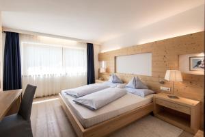 Voodi või voodid majutusasutuse Alpine Hotel Ciasa Lara toas