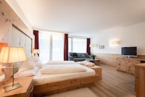 Postel nebo postele na pokoji v ubytování Alpine Hotel Ciasa Lara + 37 fotografií