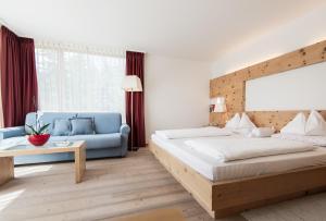Voodi või voodid majutusasutuse Alpine Hotel Ciasa Lara toas
