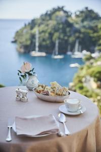 a table with a plate of food and a bowl of bread at Splendido, A Belmond Hotel, Portofino in Portofino