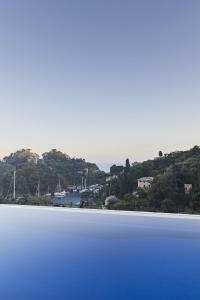 a large body of blue water with houses and trees at Splendido, A Belmond Hotel, Portofino in Portofino