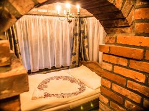 a bed in a room with a brick wall at Agroturystyka u Karoliny in Sarbinowo +136 photos