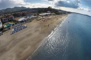 an aerial view of a beach with chairs and umbrellas at Filorian Hotel Apartments in Acharavi
